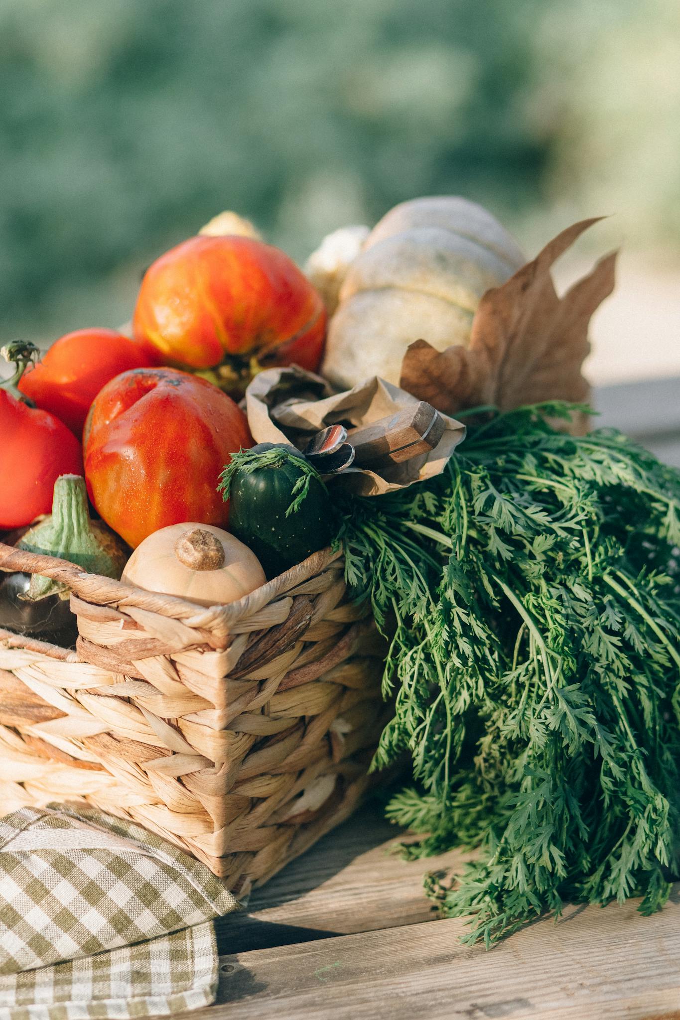 Close-up of a basket filled with fresh organic vegetables, showcasing vibrant colors and natural textures.